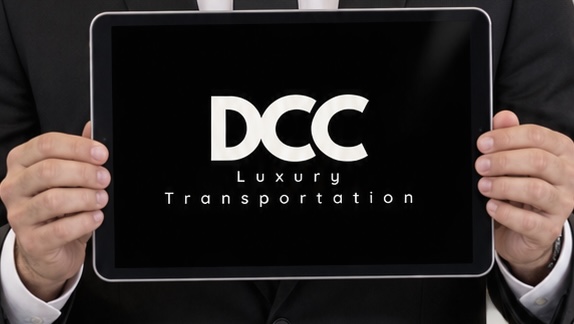 DCC chauffeur holding an iPad welcome sign for airport meet-and-greet service